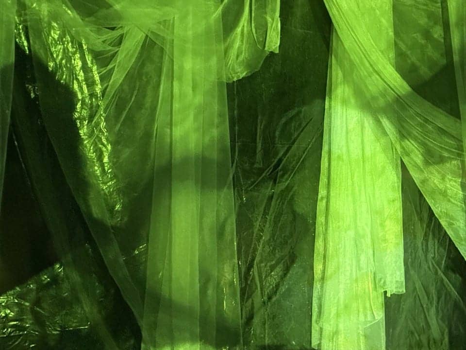 The drapes under green light.